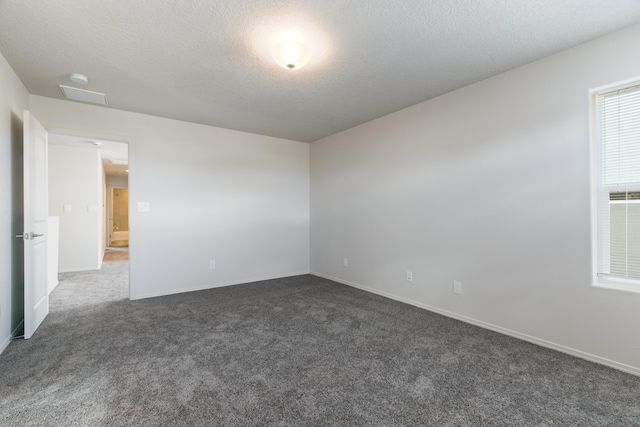 9504 Sage Ranch Ct SW, Albuquerque, NM 87121 - unfurnished room featuring dark carpet, a textured ceiling, and a smoke detector