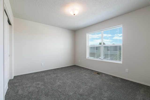 9504 Sage Ranch Ct SW, Albuquerque, NM 87121 - unfurnished room featuring dark carpet and a textured ceiling