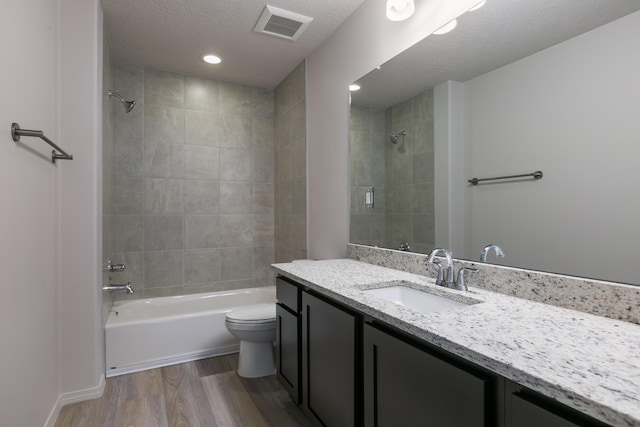 9504 Sage Ranch Ct SW, Albuquerque, NM 87121 - bathroom with vanity, bathing tub / shower combination, wood finished floors, a textured ceiling, and recessed lighting