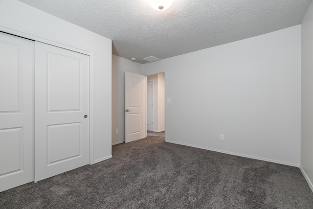 9504 Sage Ranch Ct SW, Albuquerque, NM 87121 - unfurnished bedroom featuring dark colored carpet, a textured ceiling, and a closet