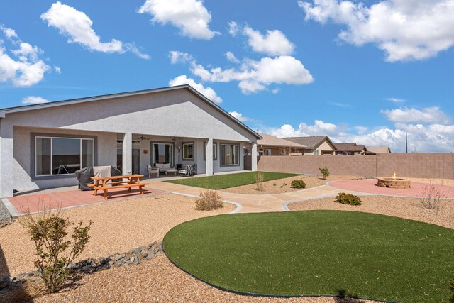 460 Rio Chama Cir SW, Los Lunas, NM 87031 - rear view of property with a fire pit, ceiling fan, stucco siding, and a patio area