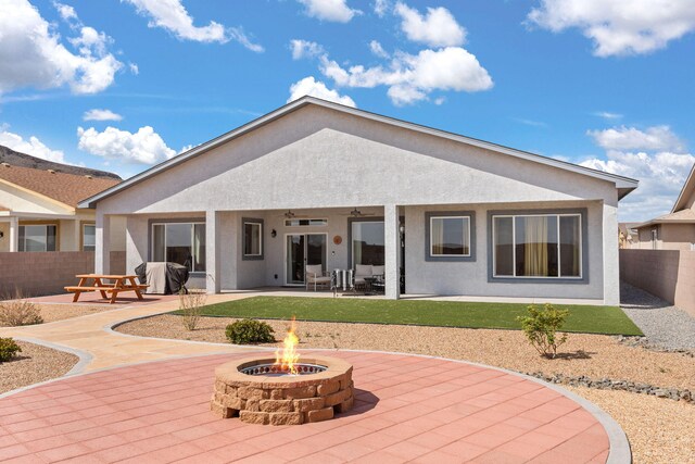 460 Rio Chama Cir SW, Los Lunas, NM 87031 - back of property featuring a fire pit, a patio, and stucco siding