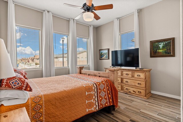 460 Rio Chama Cir SW, Los Lunas, NM 87031 - bedroom with wood finished floors, baseboards, and ceiling fan