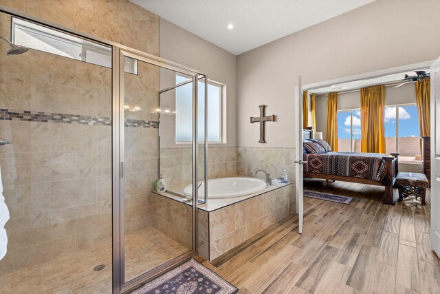 460 Rio Chama Cir SW, Los Lunas, NM 87031 - bathroom featuring connected bathroom, a garden tub, a shower stall, wood finished floors, and recessed lighting