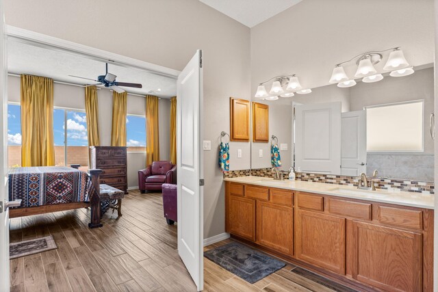 460 Rio Chama Cir SW, Los Lunas, NM 87031 - full bathroom with decorative backsplash, double vanity, and wood finished floors