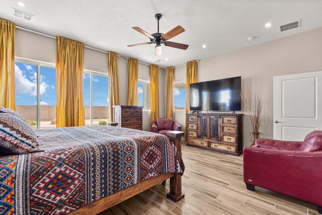 460 Rio Chama Cir SW, Los Lunas, NM 87031 - bedroom with access to exterior, wood finished floors, a textured ceiling, recessed lighting, and ceiling fan