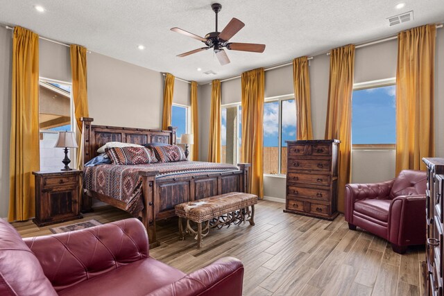 460 Rio Chama Cir SW, Los Lunas, NM 87031 - bedroom featuring a textured ceiling, light wood-style flooring, recessed lighting, ceiling fan, and baseboards
