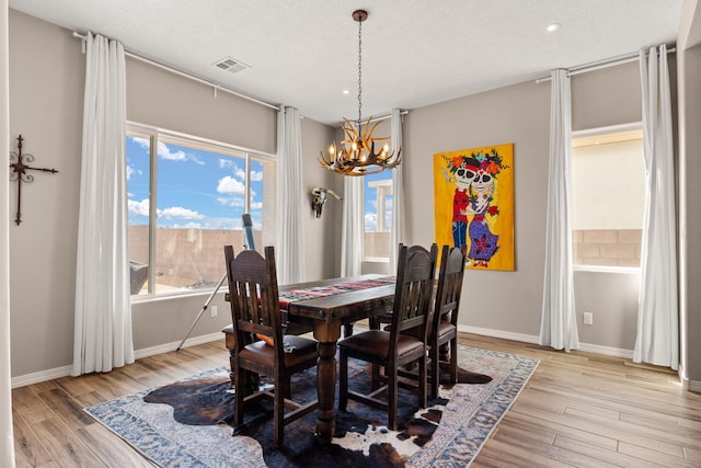 460 Rio Chama Cir SW, Los Lunas, NM 87031 - dining room featuring a chandelier, light wood-type flooring, healthy amount of natural light, baseboards, and recessed lighting