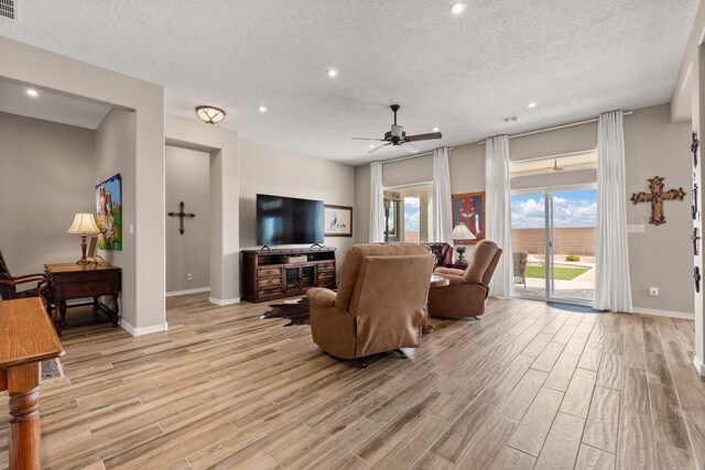 460 Rio Chama Cir SW, Los Lunas, NM 87031 - living room featuring a textured ceiling, light wood finished floors, ceiling fan, recessed lighting, and baseboards