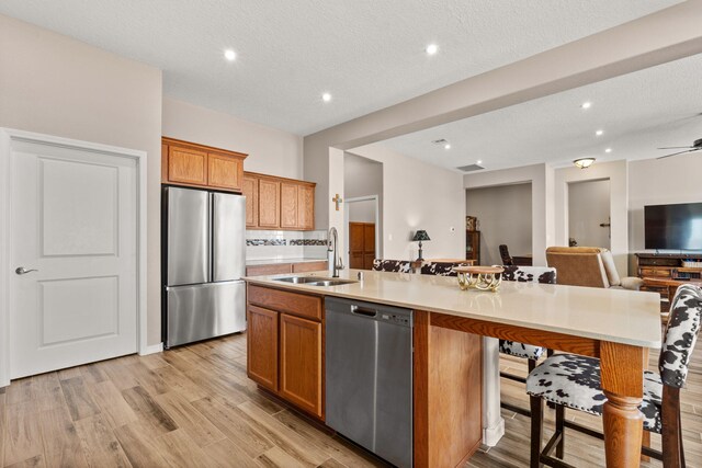 460 Rio Chama Cir SW, Los Lunas, NM 87031 - kitchen featuring appliances with stainless steel finishes, a sink, open floor plan, a large island, and light wood-style floors