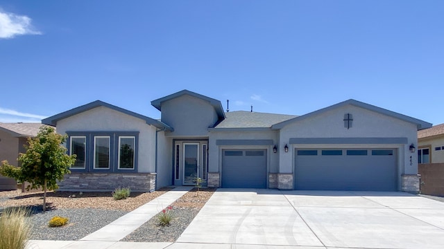 460 Rio Chama Cir SW, Los Lunas, NM 87031 - ranch-style house featuring a garage, stone siding, concrete driveway, and stucco siding