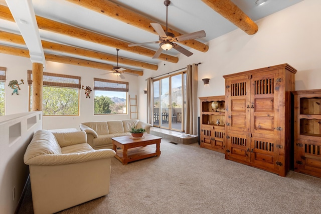 1125 Marigold Dr NE, Albuquerque, NM 87122 - carpeted living area with a healthy amount of sunlight, a ceiling fan, visible vents, and beamed ceiling