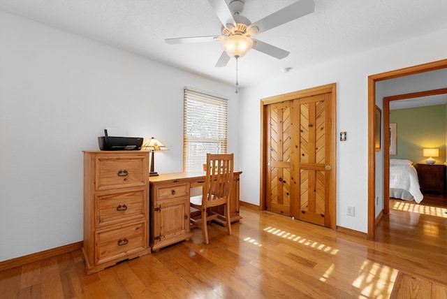 1125 Marigold Dr NE, Albuquerque, NM 87122 - home office featuring baseboards, light wood-type flooring, and a ceiling fan
