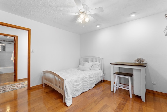 1125 Marigold Dr NE, Albuquerque, NM 87122 - bedroom featuring a ceiling fan, wood finished floors, and baseboards