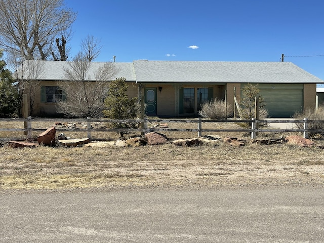 view of front facade featuring a fenced front yard and an attached garage