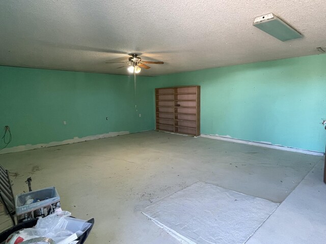 spare room featuring unfinished concrete flooring, a textured ceiling, and a ceiling fan