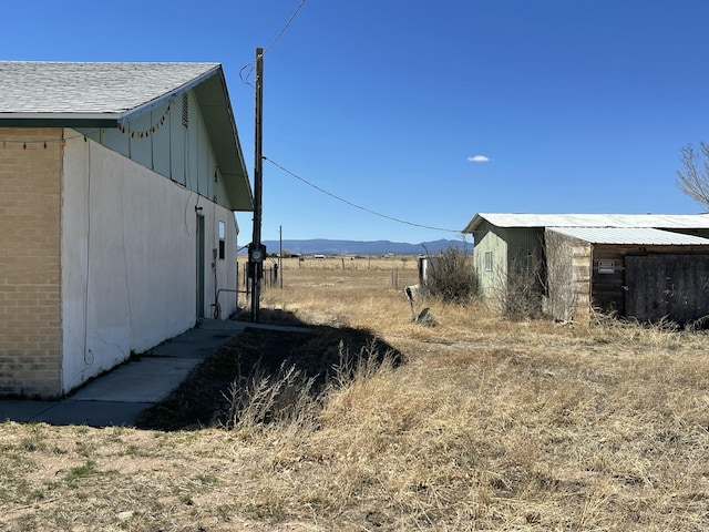 view of yard featuring an outbuilding and a mountain view