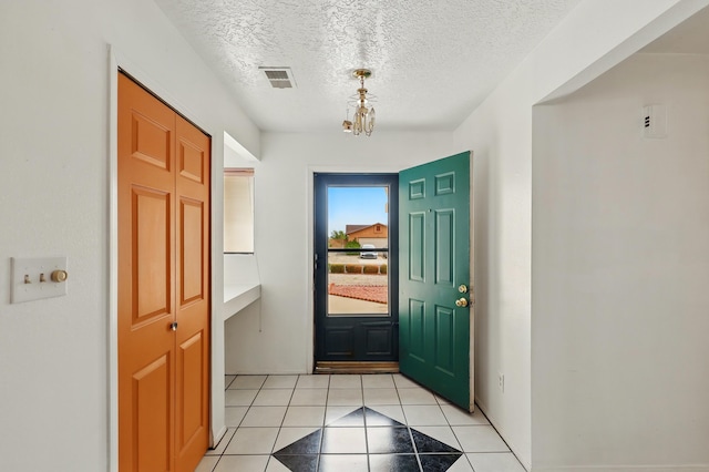 404 Pyrite Dr NE, Rio Rancho, NM 87124 - entrance foyer with light tile patterned floors and a textured ceiling