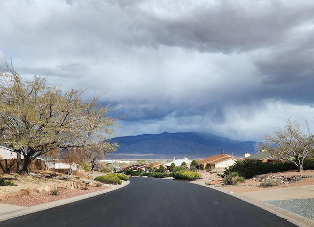 404 Pyrite Dr NE, Rio Rancho, NM 87124 - view of asphalt street featuring a mountain view and curbs