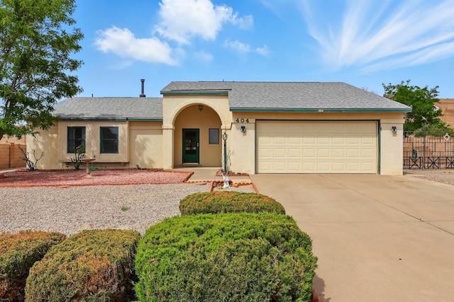 404 Pyrite Dr NE, Rio Rancho, NM 87124 - view of front facade featuring stucco siding, driveway, a garage, and a shingled roof