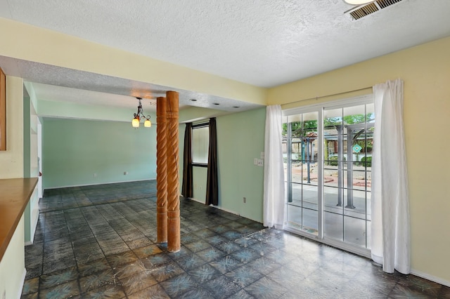 404 Pyrite Dr NE, Rio Rancho, NM 87124 - empty room featuring a textured ceiling and a chandelier