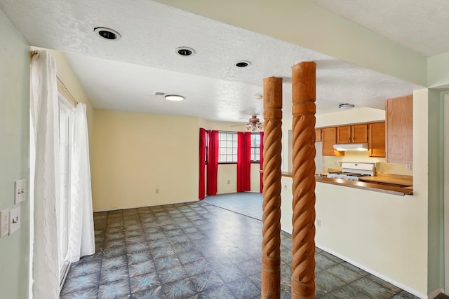 404 Pyrite Dr NE, Rio Rancho, NM 87124 - unfurnished living room featuring a textured ceiling, dark flooring, and a ceiling fan