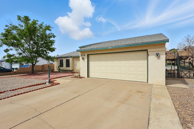 404 Pyrite Dr NE, Rio Rancho, NM 87124 - single story home featuring stucco siding, concrete driveway, a gate, and an attached garage