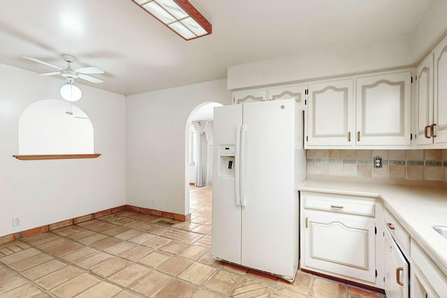 7827 Academy Trl NE, Albuquerque, NM 87109 - kitchen featuring white refrigerator with ice dispenser, a ceiling fan, arched walkways, baseboards, and light countertops