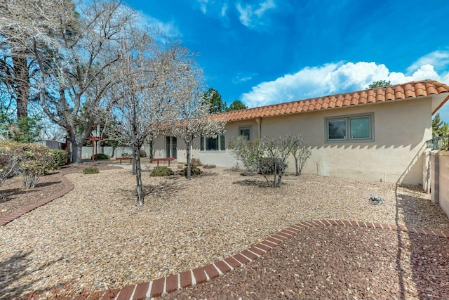7827 Academy Trl NE, Albuquerque, NM 87109 - rear view of house featuring a tile roof and stucco siding