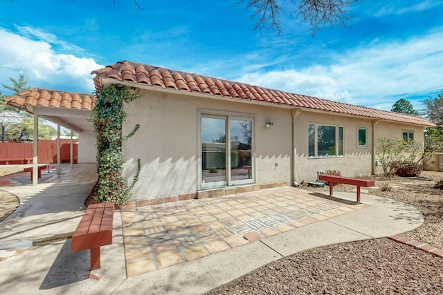 7827 Academy Trl NE, Albuquerque, NM 87109 - back of house featuring stucco siding, a tile roof, and a patio area
