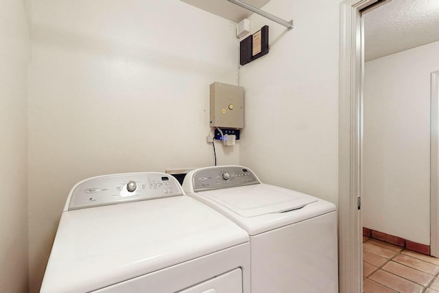 7827 Academy Trl NE, Albuquerque, NM 87109 - laundry room with washer and clothes dryer and light tile patterned flooring