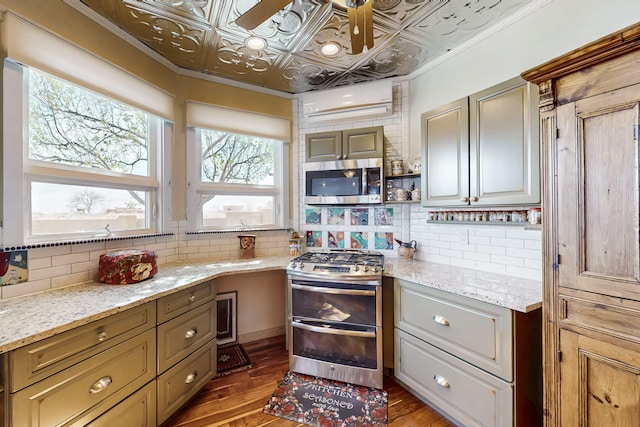 2544 Sandia Loop NE, Rio Rancho, NM 87144 - kitchen featuring stainless steel appliances, wood finished floors, and tasteful backsplash