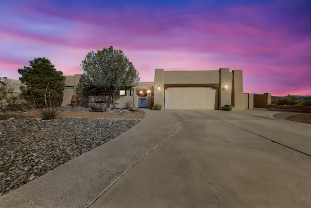 2544 Sandia Loop NE, Rio Rancho, NM 87144 - pueblo-style home with an attached garage, driveway, and stucco siding