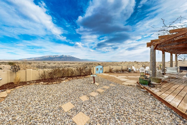 2544 Sandia Loop NE, Rio Rancho, NM 87144 - view of yard featuring a patio, a pergola, a deck with mountain view, and a fenced backyard