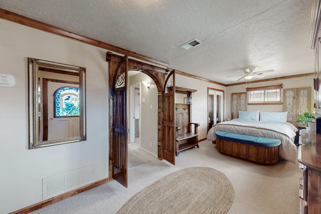 bedroom featuring arched walkways, visible vents, light carpet, and ornamental molding