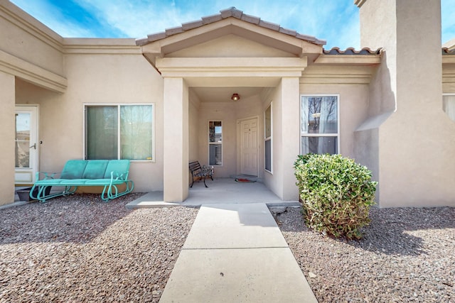 view of exterior entry featuring stucco siding