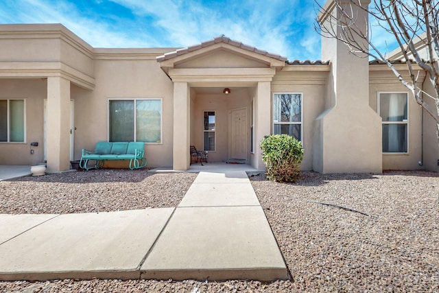 property entrance with stucco siding