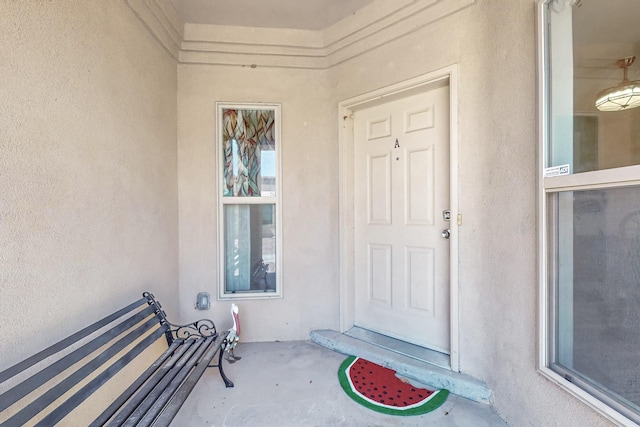 entrance to property with stucco siding