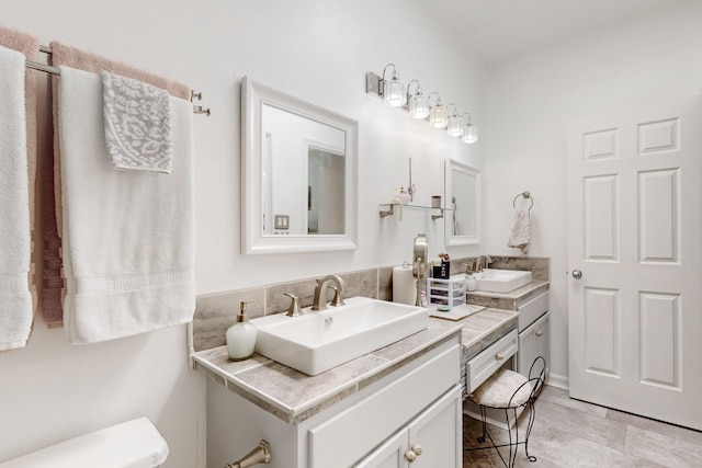 bathroom featuring toilet and vanity