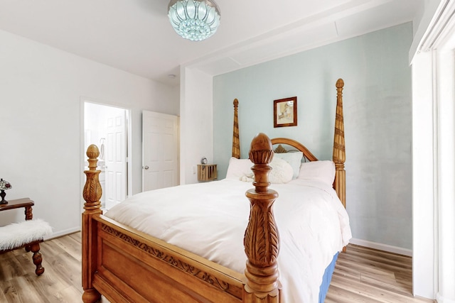 bedroom with baseboards and light wood-style flooring