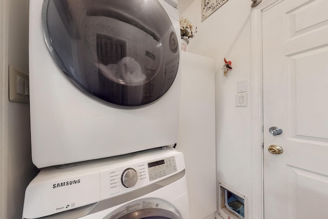 clothes washing area with stacked washer / drying machine and laundry area