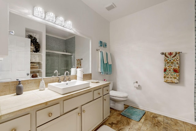 bathroom with visible vents, baseboards, toilet, vanity, and a stall shower