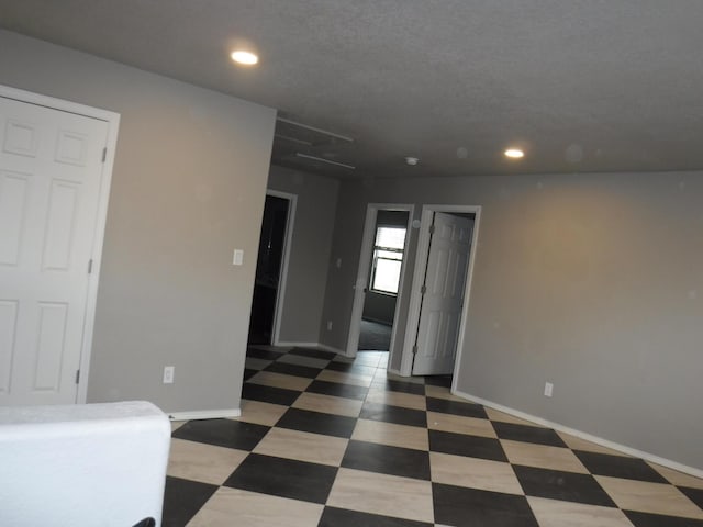 spare room featuring baseboards, tile patterned floors, and recessed lighting
