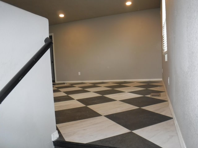 empty room featuring a textured wall and recessed lighting