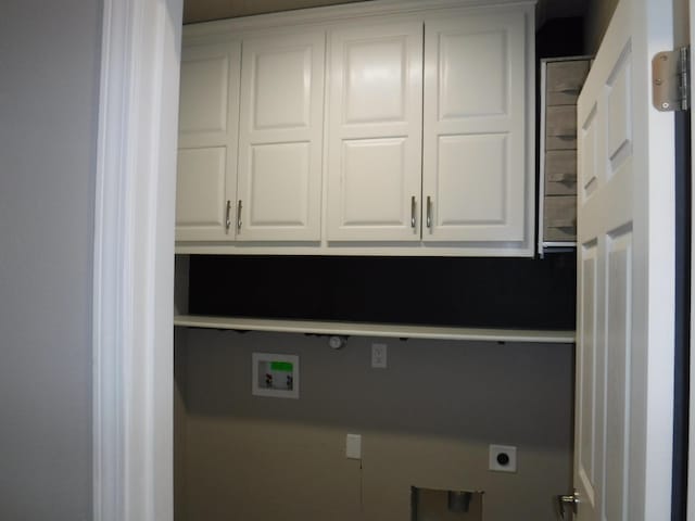 clothes washing area with cabinet space, washer hookup, and electric dryer hookup