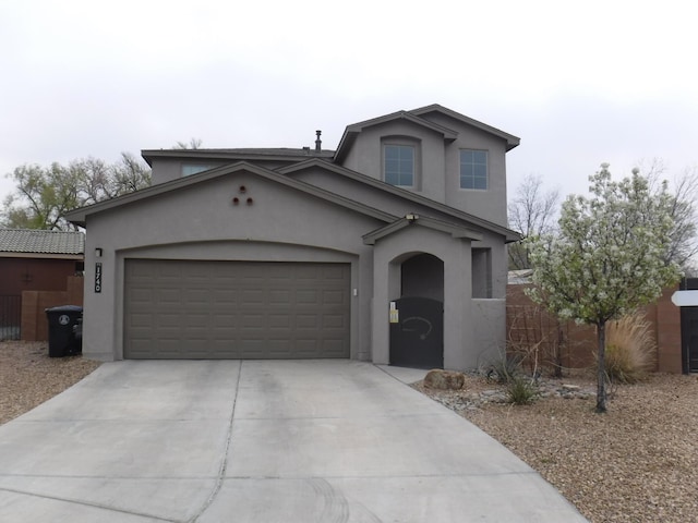 view of front of home featuring stucco siding, driveway, and a garage