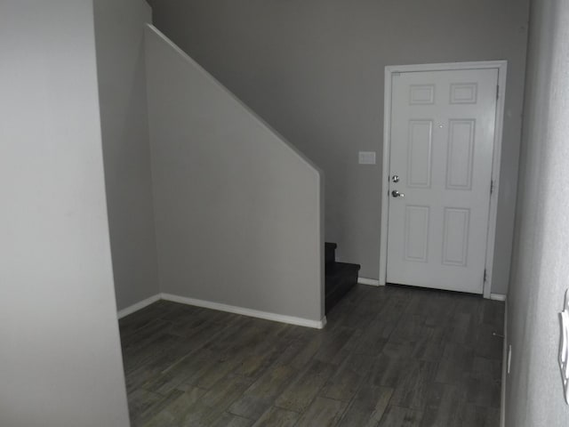 foyer entrance with baseboards, stairway, and dark wood-style floors