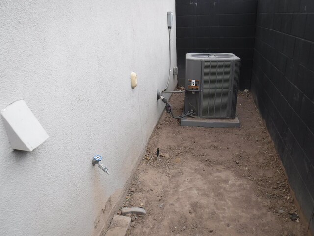 exterior details with stucco siding and central AC unit