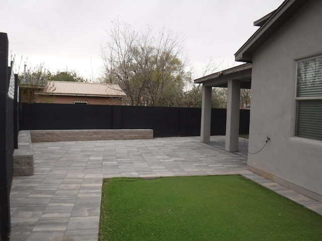 view of yard featuring a fenced backyard and a patio area