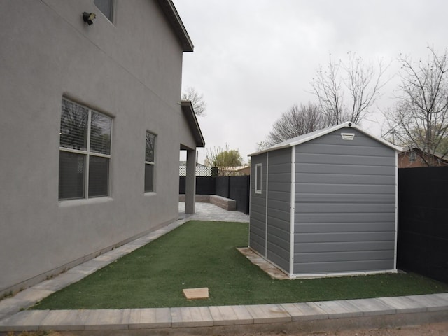 exterior space featuring an outbuilding, a shed, and a fenced backyard